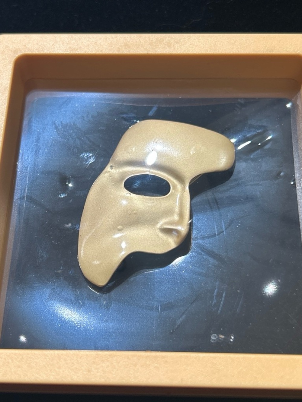 Gold color Phantom Mask brooch has minor uneven color/ peel and discoloration